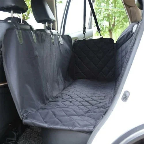 Black quilted waterproof car seat cover installed on rear seat for pet protection and travel