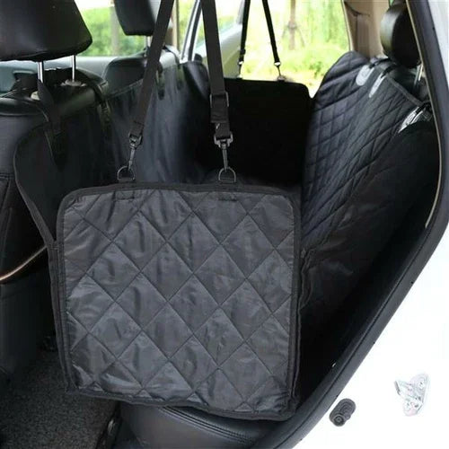 Black quilted protective pet car seat cover with side flaps installed in back seat of a vehicle