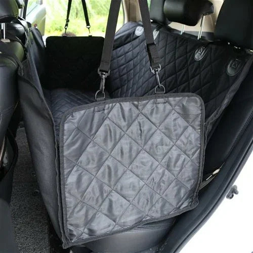 Black quilted waterproof dog car seat cover protecting backseat with adjustable straps in car